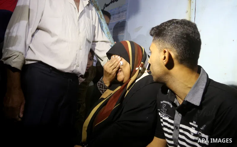 A Palestinian woman reacts after her relative was killed after Israel blew up what it said was a tunnel stretching from the Gaza Strip into its territory, at a morgue at al-Aqsa hospital in Deir el-Balah, in central Gaza...