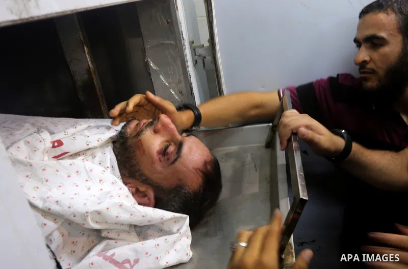 The body of a Palestinian man killed after Israel blew up what it said was a tunnel stretching from the Gaza Strip into its territory, lies at a morgue at al-Aqsa hospital in Deir el-Balah, in central Gaza, on October 30...