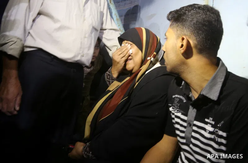 A Palestinian woman reacts after her relative was killed after Israel blew up what it said was a tunnel stretching from the Gaza Strip into its territory, at a morgue at al-Aqsa hospital in Deir el-Balah, in central Gaza...