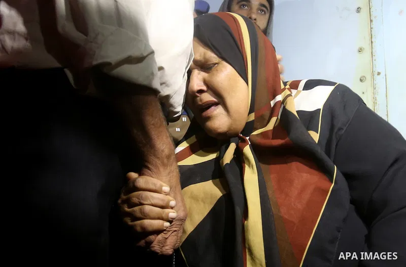 A Palestinian woman reacts after her relative was killed after Israel blew up what it said was a tunnel stretching from the Gaza Strip into its territory, at a morgue at al-Aqsa hospital in Deir el-Balah, in central Gaza...