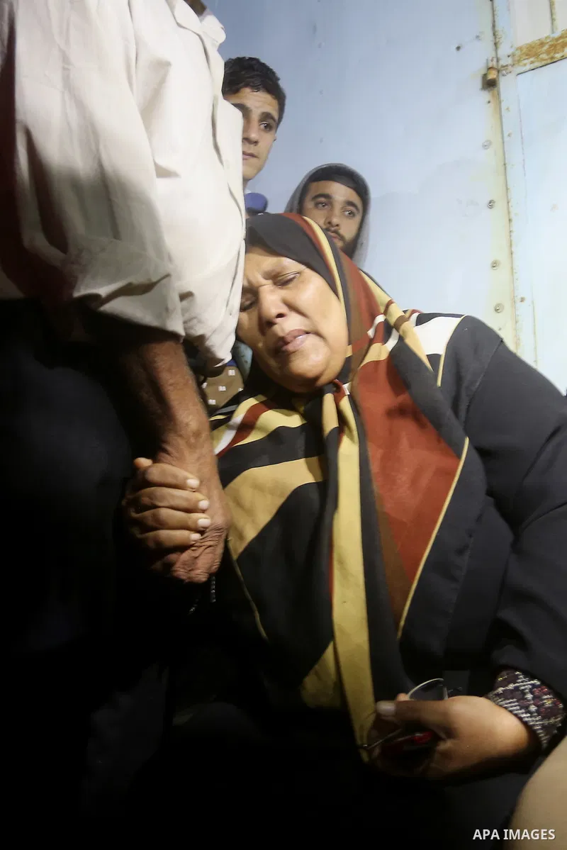 A Palestinian woman reacts after her relative was killed after Israel blew up what it said was a tunnel stretching from the Gaza Strip into its territory, at a morgue at al-Aqsa hospital in Deir el-Balah, in central Gaza...