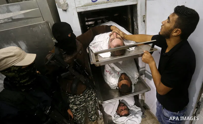 The bodies of Palestinians killed after Israel blew up what it said was a tunnel stretching from the Gaza Strip into its territory, lie at a morgue at al-Aqsa hospital in Deir el-Balah, in central Gaza, on October 30, 20...