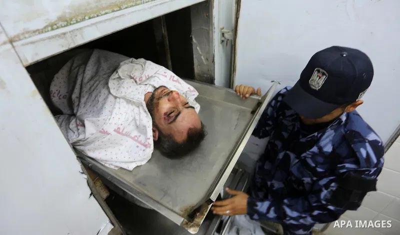 The body of Palestinian killed after Israel blew up what it said was a tunnel stretching from the Gaza Strip into its territory, lies at a morgue at al-Aqsa hospital in Deir el-Balah, in central Gaza, on October 30, 2017...