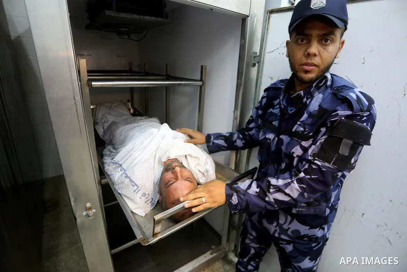 The body of Palestinian killed after Israel blew up what it said was a tunnel stretching from the Gaza Strip into its territory, lies at a morgue at al-Aqsa hospital in Deir el-Balah, in central Gaza, on October 30, 2017...