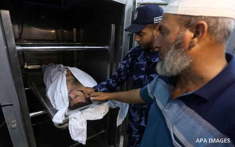The body of Palestinian killed after Israel blew up what it said was a tunnel stretching from the Gaza Strip into its territory, lies at a morgue at al-Aqsa hospital in Deir el-Balah, in central Gaza, on October 30, 2017...