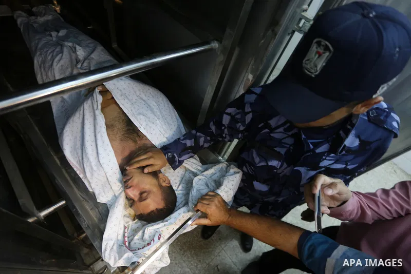 The body of Palestinian killed after Israel blew up what it said was a tunnel stretching from the Gaza Strip into its territory, lies at a morgue at al-Aqsa hospital in Deir el-Balah, in central Gaza, on October 30, 2017...