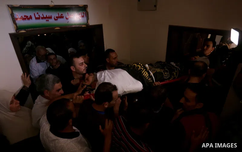 Palestinian relatives of Hassan Abu Hassanin who were killed the previous day in an Israeli operation to blow up a tunnel stretching from the Gaza Strip into Israel, mourn during his funeral in Bureij refugee camp in cen...