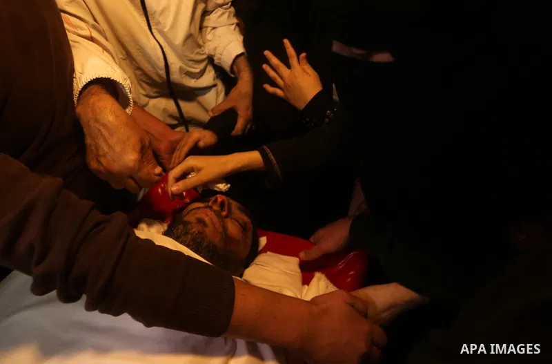 Palestinian relatives of Hassan Abu Hassanin who were killed the previous day in an Israeli operation to blow up a tunnel stretching from the Gaza Strip into Israel, mourn during his funeral in Bureij refugee camp in cen...