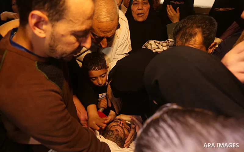 Palestinian relatives of Hassan Abu Hassanin who were killed the previous day in an Israeli operation to blow up a tunnel stretching from the Gaza Strip into Israel, mourn during his funeral in Bureij refugee camp in cen...
