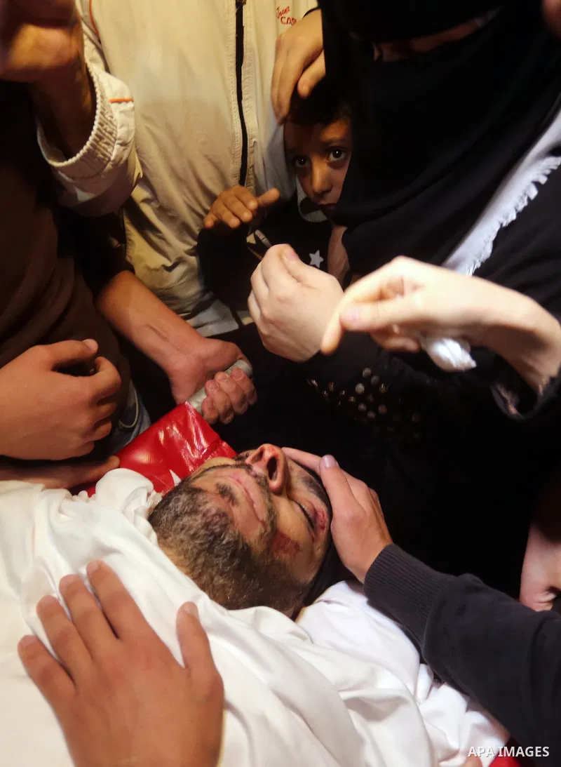 Palestinian relatives of Hassan Abu Hassanin who were killed the previous day in an Israeli operation to blow up a tunnel stretching from the Gaza Strip into Israel, mourn during his funeral in Bureij refugee camp in cen...