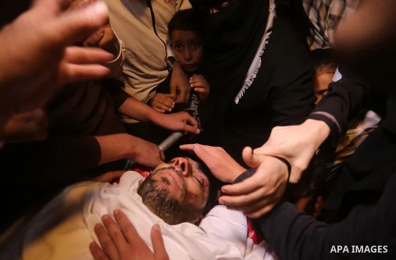 Palestinian relatives of Hassan Abu Hassanin who were killed the previous day in an Israeli operation to blow up a tunnel stretching from the Gaza Strip into Israel, mourn during his funeral in Bureij refugee camp in cen...