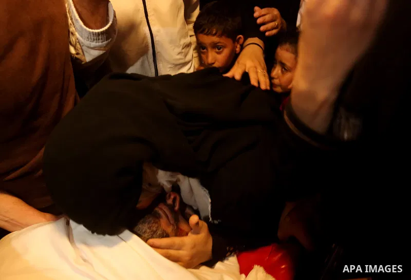 Palestinian relatives of Hassan Abu Hassanin who were killed the previous day in an Israeli operation to blow up a tunnel stretching from the Gaza Strip into Israel, mourn during his funeral in Bureij refugee camp in cen...