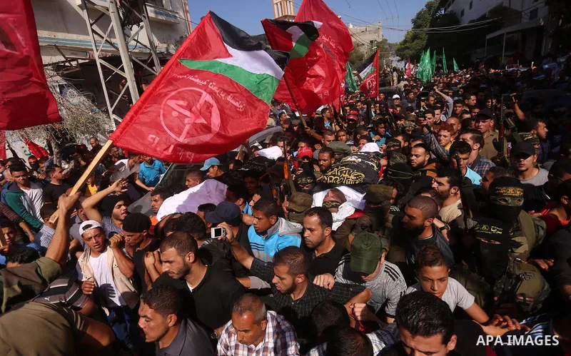Palestinian mourners carry the body of Palestinian Islamic Jihad Movement fighter Arafat Abu Morshed during the funeral of Palestinians killed in an Israeli operation to blow up a tunnel stretching from the Gaza Strip in...