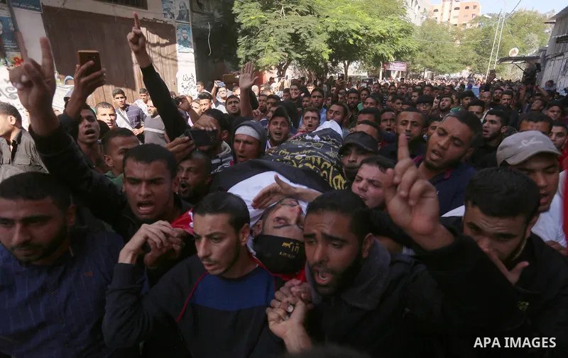 Palestinian mourners carry the body of Hassan Abu Hassanin in Bureij refugee camp in central Gaza Strip on October 31, 2017, during the funeral of Palestinians who were killed the previous day in an Israeli operation to...