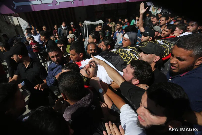 Palestinian mourners carry the body of one of the Palestinians killed in an Israeli operation to blow up a tunnel stretching from the Gaza Strip into Israel during their funeral in Bureij refugee camp in central Gaza Str...
