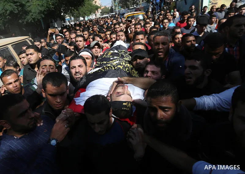 Palestinian mourners carry the body of one of the Palestinians killed in an Israeli operation to blow up a tunnel stretching from the Gaza Strip into Israel during their funeral in Bureij refugee camp in central Gaza Str...