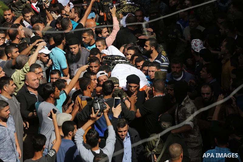 Palestinian mourners carry the body of one of the Palestinians killed in an Israeli operation to blow up a tunnel stretching from the Gaza Strip into Israel during their funeral in Bureij refugee camp in central Gaza Str...