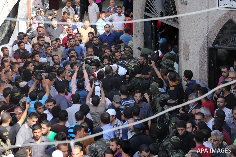Palestinian mourners carry the body of one of the Palestinians killed in an Israeli operation to blow up a tunnel stretching from the Gaza Strip into Israel during their funeral in Bureij refugee camp in central Gaza Str...