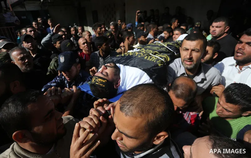 Palestinian mourners carry the body of one of the Palestinians killed in an Israeli operation to blow up a tunnel stretching from the Gaza Strip into Israel during their funeral in Bureij refugee camp in central Gaza Str...