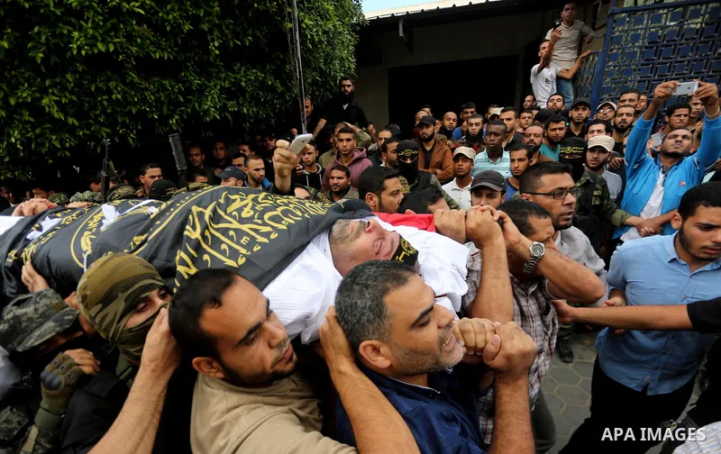 Palestinian mourners carry the body of one of the Palestinians killed in an Israeli operation to blow up a tunnel stretching from the Gaza Strip into Israel during their funeral in Bureij refugee camp in central Gaza Str...