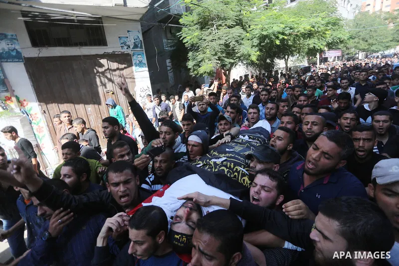 Palestinian mourners carry the body of one of the Palestinians killed in an Israeli operation to blow up a tunnel stretching from the Gaza Strip into Israel during their funeral in Bureij refugee camp in central Gaza Str...