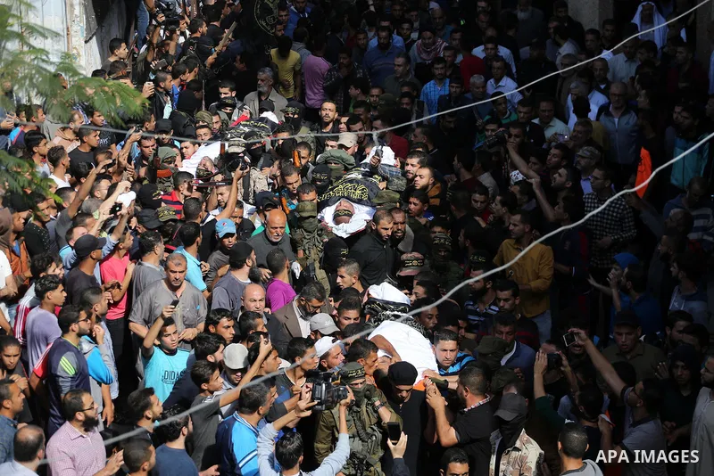 Palestinian mourners carry the body of one of the Palestinians killed in an Israeli operation to blow up a tunnel stretching from the Gaza Strip into Israel during their funeral in Bureij refugee camp in central Gaza Str...