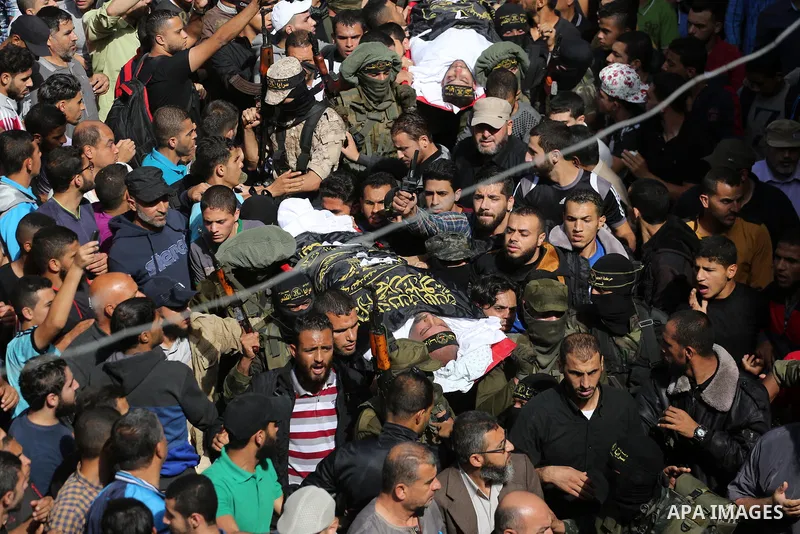Palestinian mourners carry the body of one of the Palestinians killed in an Israeli operation to blow up a tunnel stretching from the Gaza Strip into Israel during their funeral in Bureij refugee camp in central Gaza Str...