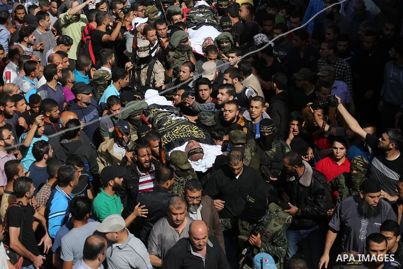 Palestinian mourners carry the body of one of the Palestinians killed in an Israeli operation to blow up a tunnel stretching from the Gaza Strip into Israel during their funeral in Bureij refugee camp in central Gaza Str...