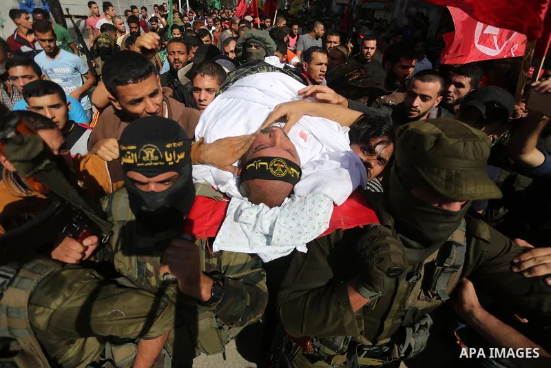 Palestinian mourners carry the body of one of the Palestinians killed in an Israeli operation to blow up a tunnel stretching from the Gaza Strip into Israel during their funeral in Bureij refugee camp in central Gaza Str...