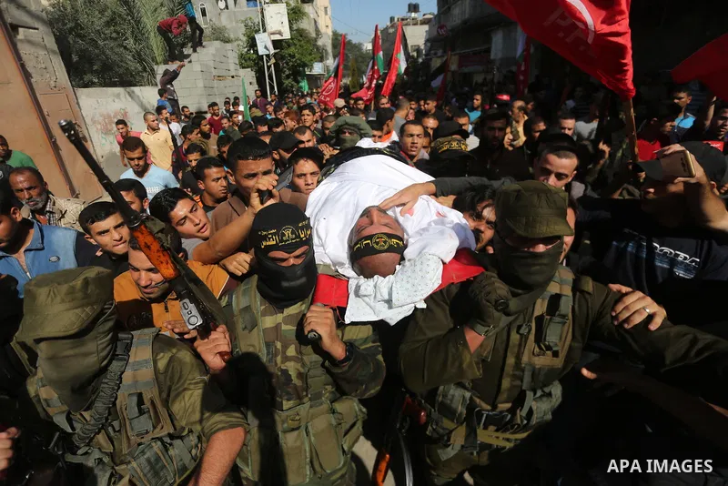 Palestinian mourners carry the body of one of the Palestinians killed in an Israeli operation to blow up a tunnel stretching from the Gaza Strip into Israel during their funeral in Bureij refugee camp in central Gaza Str...