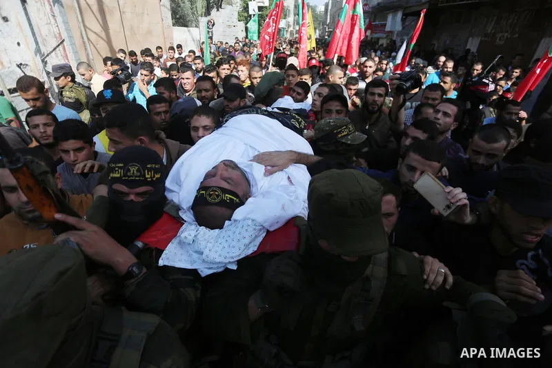 Palestinian mourners carry the body of one of the Palestinians killed in an Israeli operation to blow up a tunnel stretching from the Gaza Strip into Israel during their funeral in Bureij refugee camp in central Gaza Str...