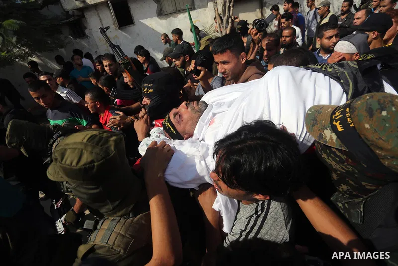 Palestinian mourners carry the body of one of the Palestinians killed in an Israeli operation to blow up a tunnel stretching from the Gaza Strip into Israel during their funeral in Bureij refugee camp in central Gaza Str...