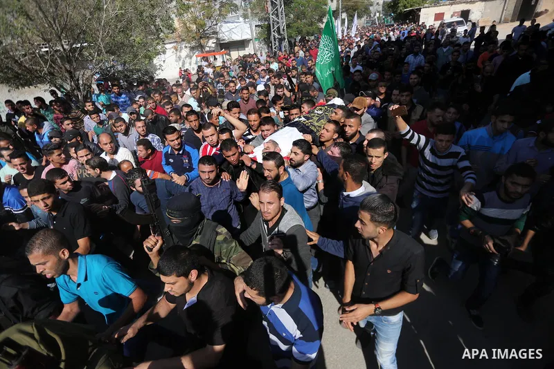 Palestinian mourners carry the body of one of the Palestinians killed in an Israeli operation to blow up a tunnel stretching from the Gaza Strip into Israel during their funeral in Bureij refugee camp in central Gaza Str...