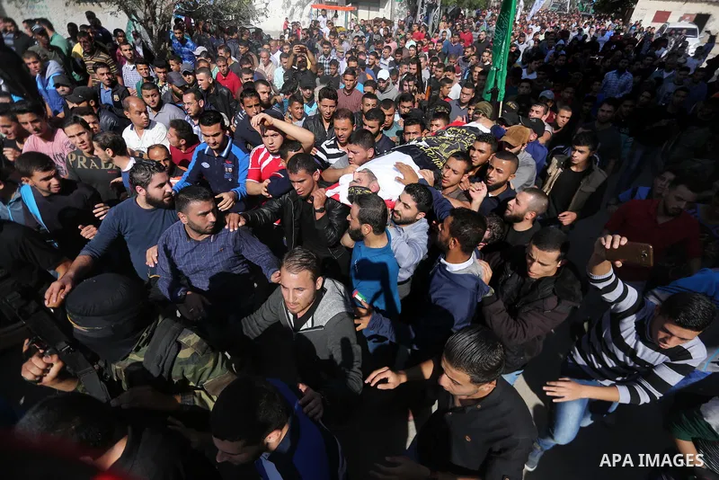 Palestinian mourners carry the body of one of the Palestinians killed in an Israeli operation to blow up a tunnel stretching from the Gaza Strip into Israel during their funeral in Bureij refugee camp in central Gaza Str...