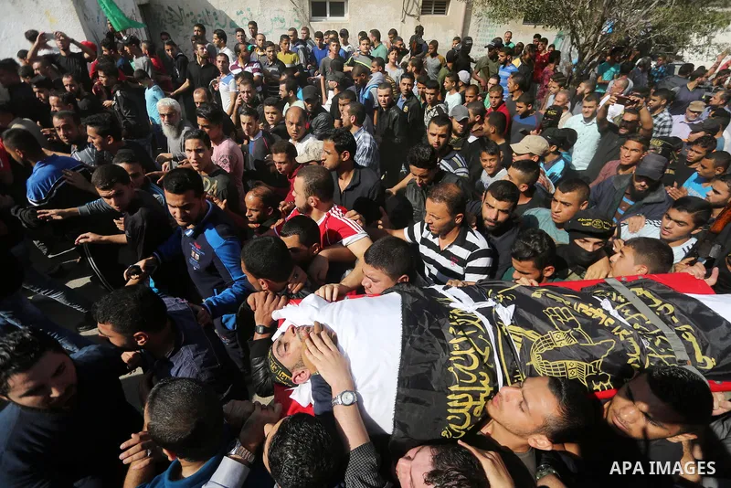 Palestinian mourners carry the body of one of the Palestinians killed in an Israeli operation to blow up a tunnel stretching from the Gaza Strip into Israel during their funeral in Bureij refugee camp in central Gaza Str...