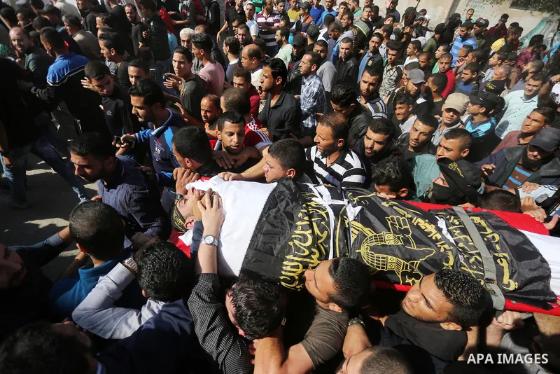 Palestinian mourners carry the body of one of the Palestinians killed in an Israeli operation to blow up a tunnel stretching from the Gaza Strip into Israel during their funeral in Bureij refugee camp in central Gaza Str...