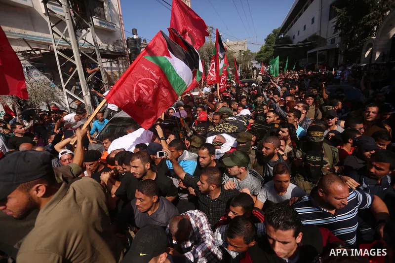 Palestinian mourners carry the body of Palestinian Islamic Jihad Movement fighter Arafat Abu Morshed during the funeral of Palestinians killed in an Israeli operation to blow up a tunnel stretching from the Gaza Strip in...