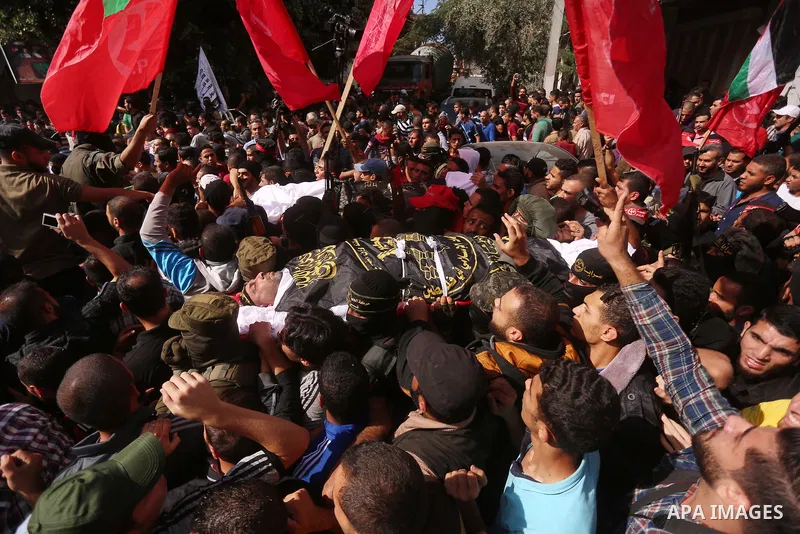 Palestinian mourners carry the body of Palestinian Islamic Jihad Movement fighter Arafat Abu Morshed during the funeral of Palestinians killed in an Israeli operation to blow up a tunnel stretching from the Gaza Strip in...