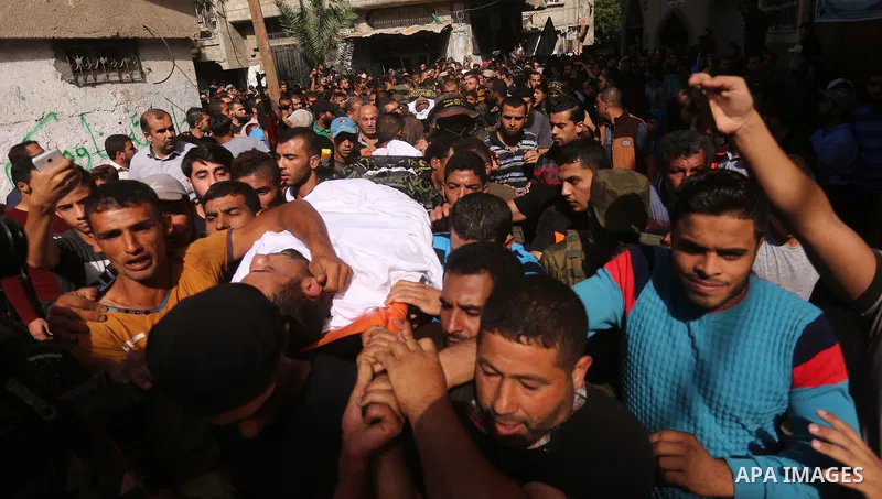 Palestinian mourners carry the body of one of the Palestinians killed in an Israeli operation to blow up a tunnel stretching from the Gaza Strip into Israel during their funeral in Bureij refugee camp in central Gaza Str...