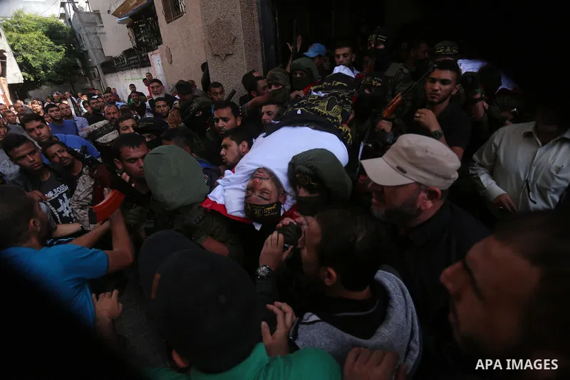 Palestinian mourners carry the body of Hassan Abu Hassanin in Bureij refugee camp in central Gaza Strip on October 31, 2017, during the funeral of Palestinians who were killed the previous day in an Israeli operation to...