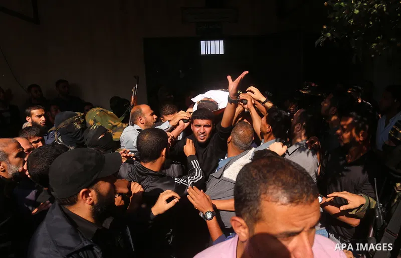 Palestinian mourners carry the body of one of the Palestinians killed in an Israeli operation to blow up a tunnel stretching from the Gaza Strip into Israel during their funeral in Bureij refugee camp in central Gaza Str...