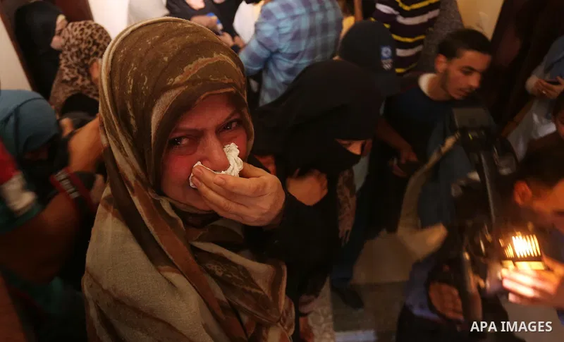 Palestinian relatives of Hassan Abu Hassanin who were killed the previous day in an Israeli operation to blow up a tunnel stretching from the Gaza Strip into Israel, mourn during his funeral in Bureij refugee camp in cen...