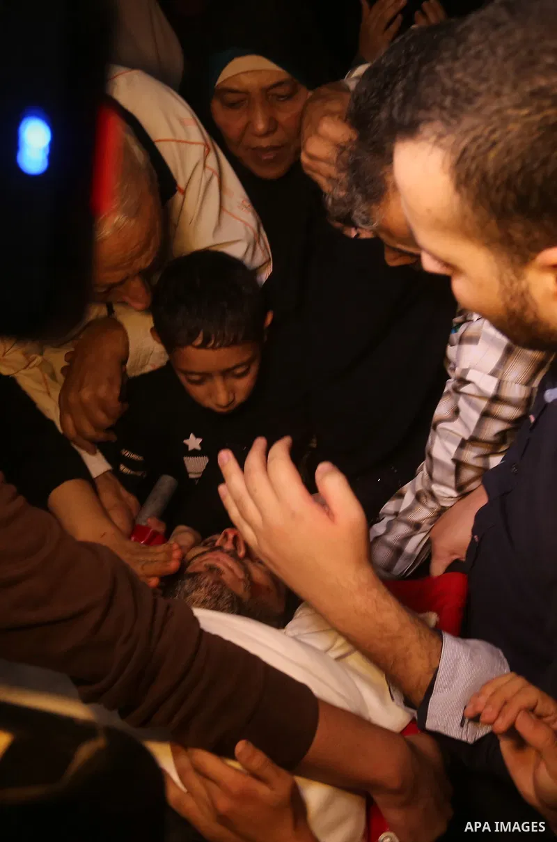 Palestinian relatives of Hassan Abu Hassanin who were killed the previous day in an Israeli operation to blow up a tunnel stretching from the Gaza Strip into Israel, mourn during his funeral in Bureij refugee camp in cen...