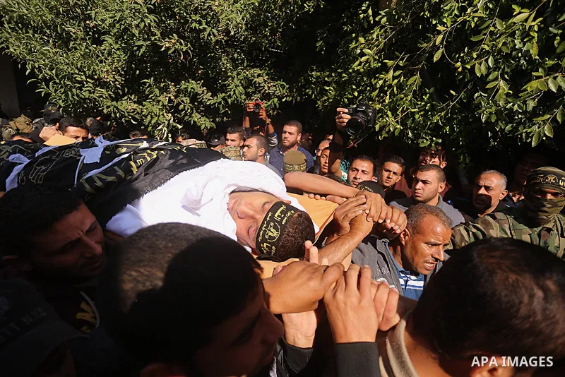 Palestinian mourners carry the body of one of the Palestinians killed in an Israeli operation to blow up a tunnel stretching from the Gaza Strip into Israel during their funeral in Bureij refugee camp in central Gaza Str...