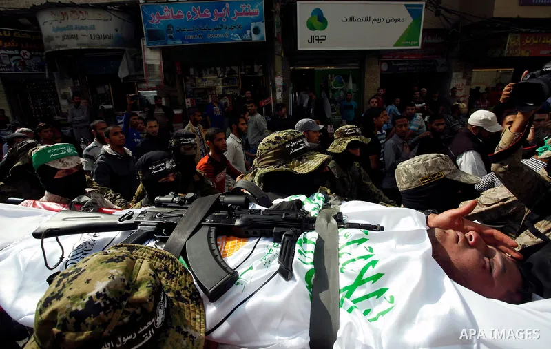 Palestinian mourners and fighters from the Ezzedine al-Qassam Brigades, the armed wing of the Palestinian Hamas movement, carry the body of 30-year-old Mosbah Shabir in Khan Yunis, in the southern Gaza Strip, on October...