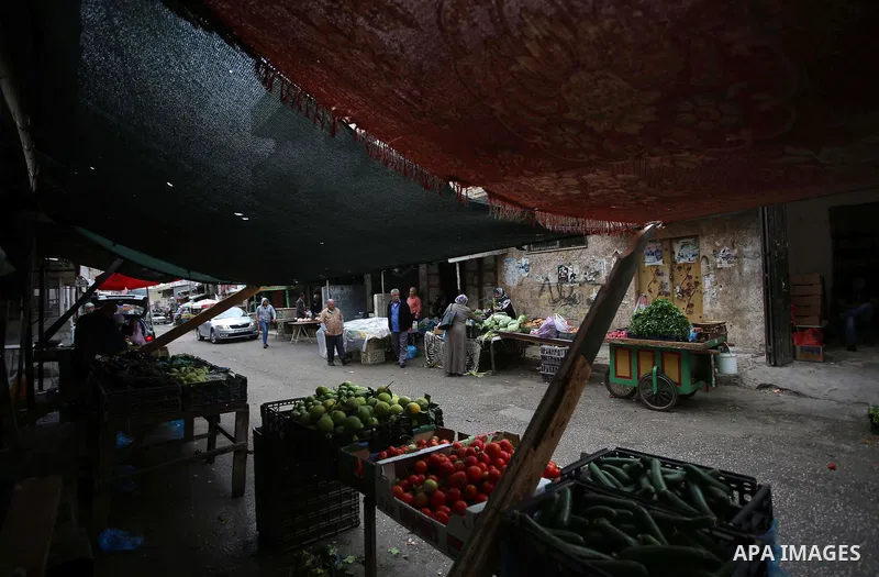 Palestinians shop at a market in the Balata refugee camp near the West Bank city of Nablus, on November 1, 2017. This week, Palestinians around the world are marking 100 years since the Balfour Declaration was issued on...