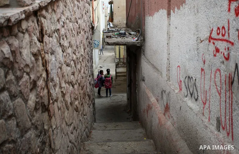 Palestinian students walk on a street at Balata refugee camp near in the West Bank city of Nablus, on November 1, 2017. This week, Palestinians around the world are marking 100 years since the Balfour Declaration was iss...