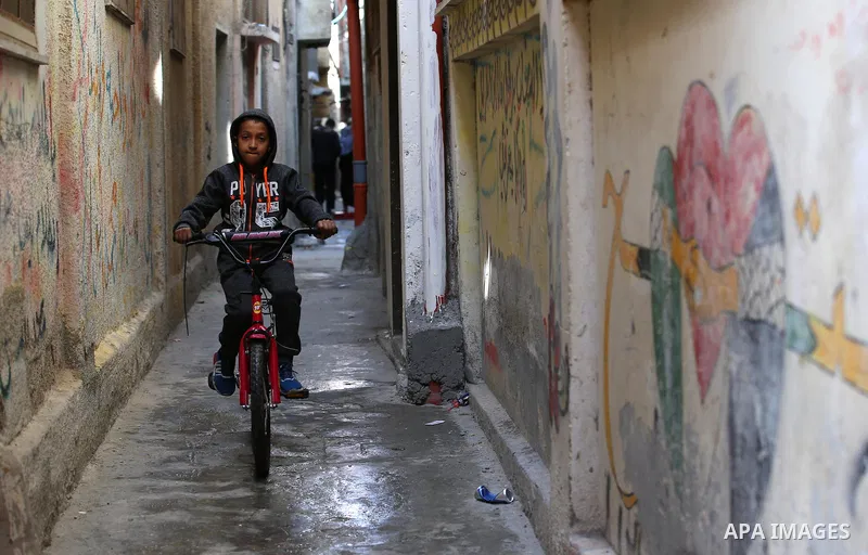 A Palestinian boy plays outside his house at Balata refugee camp near in the West Bank city of Nablus, on November 1, 2017. This week, Palestinians around the world are marking 100 years since the Balfour Declaration was...