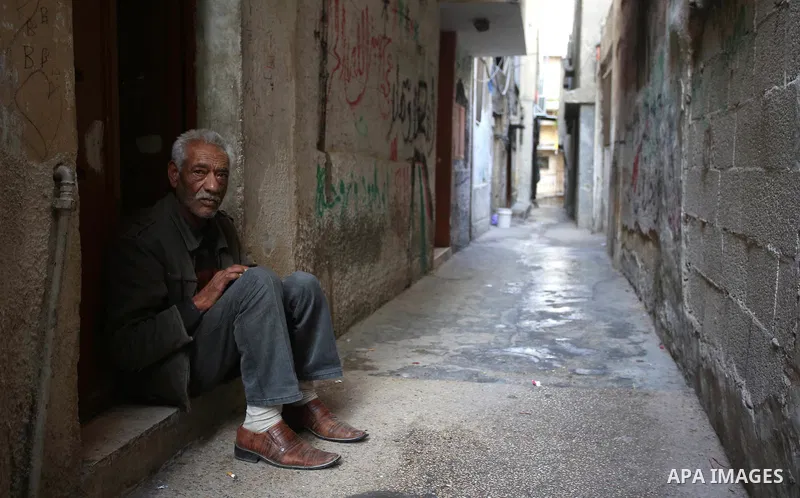 A Palestinian man sits outside his house at Balata refugee camp near in the West Bank city of Nablus, on November 1, 2017. This week, Palestinians around the world are marking 100 years since the Balfour Declaration was...