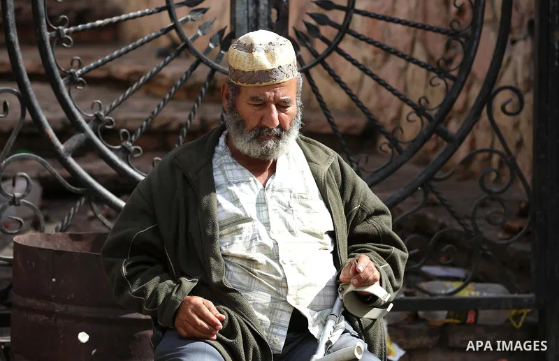 A Palestinian man sits outside his house at Balata refugee camp near in the West Bank city of Nablus, on November 1, 2017. This week, Palestinians around the world are marking 100 years since the Balfour Declaration was...